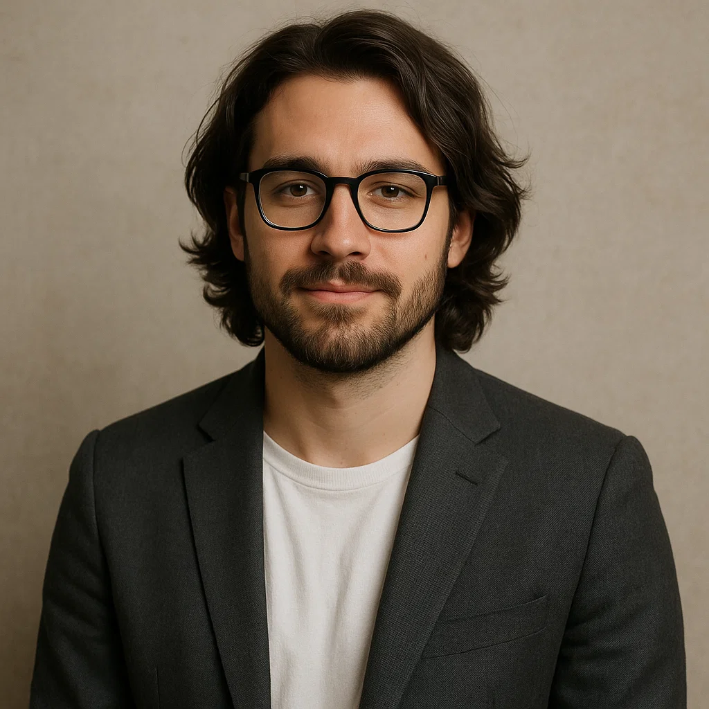 Man with medium-length hairstyle wearing blazer and glasses